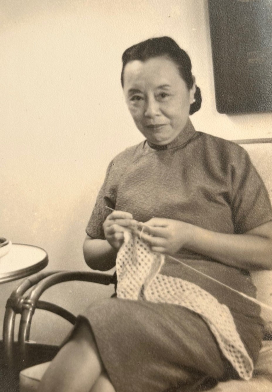 2024.010.028 Zhang Youyi sitting on a chair crocheting. Courtesy of Fern Tse and Margaret Mow, Museum of Chinese in America (MOCA) Collection.